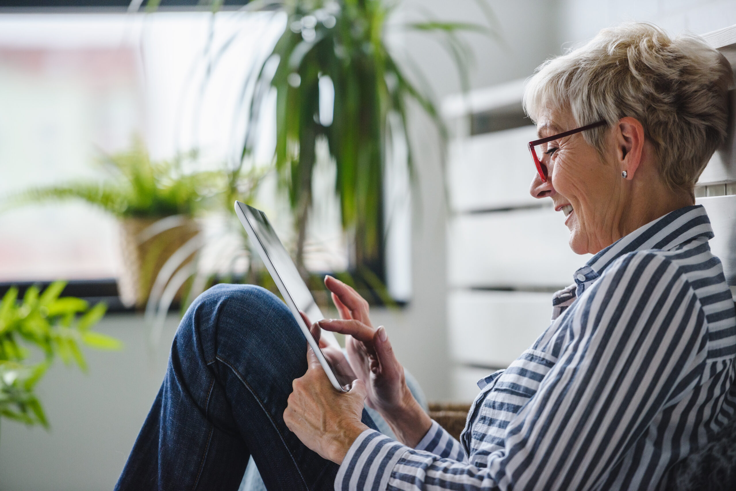 Senior woman using digital tablet at home. The use of technology Group of buddies