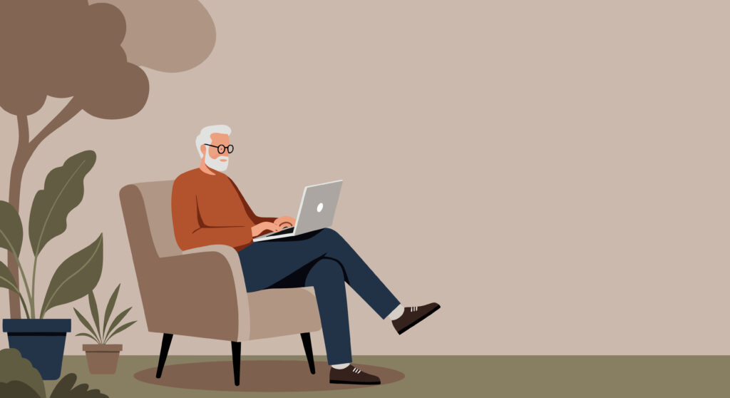 Older man sitting in chair on laptop